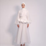 Cloud Peplum Dress in White by Kharzaat featuring a ruffled peplum waist, bishop sleeves, and flowing chiffon fabric