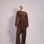 Draped Waist 3-Piece Set in Brown by Kharzaat featuring a long-sleeve top, wide-leg pants, and removable draped waist piece