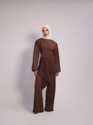 Draped Waist 3-Piece Set in Brown by Kharzaat featuring a long-sleeve top, wide-leg pants, and removable draped waist piece
